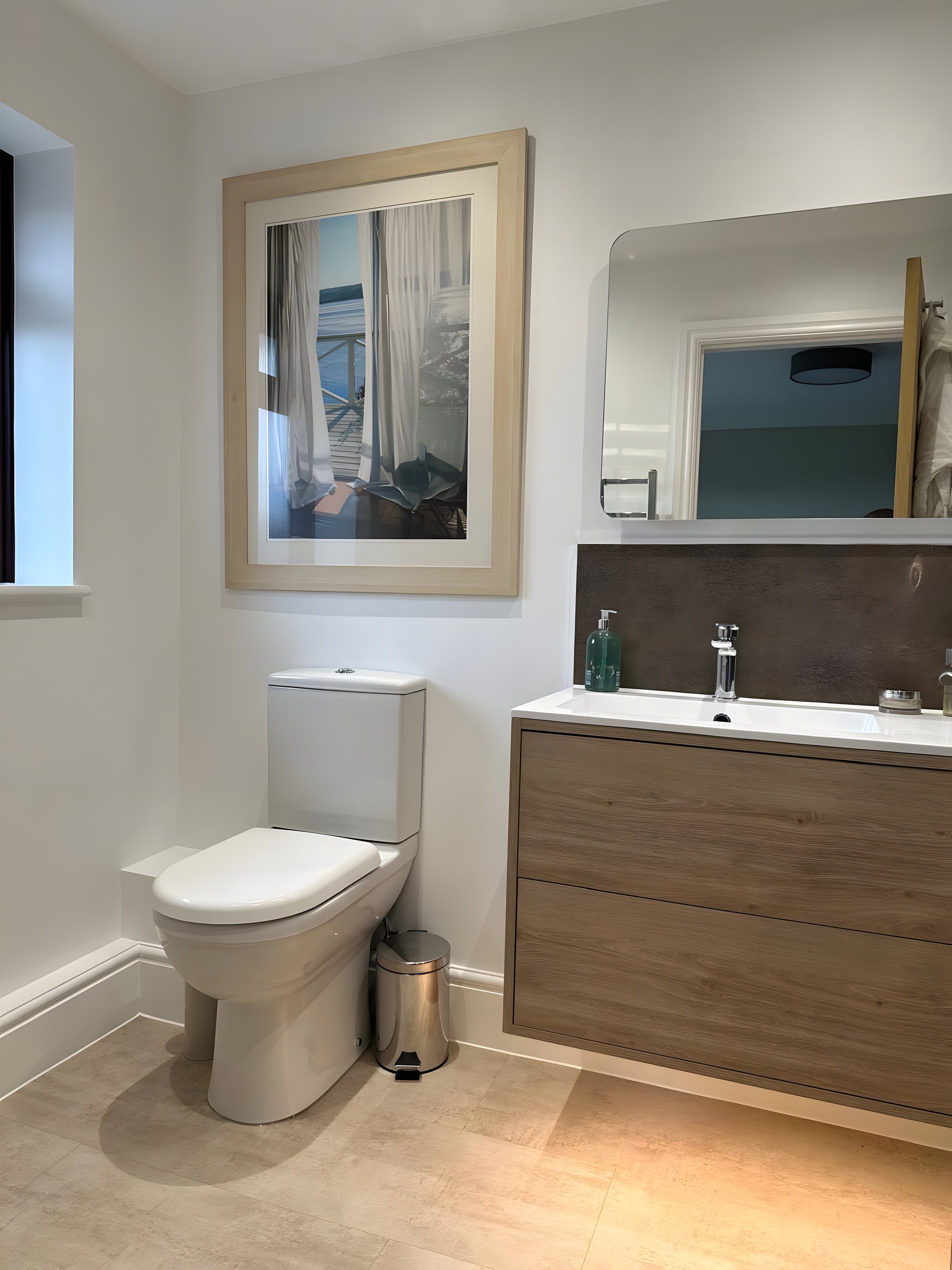 En-suite with oak vanity unit and illuminated mirror