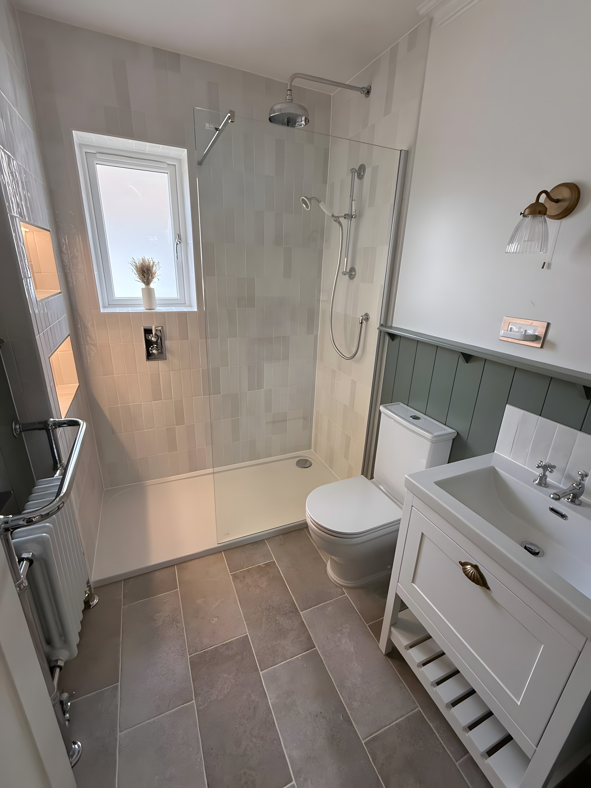 Light shower room with sage panelling, white washstand and walk-in shower