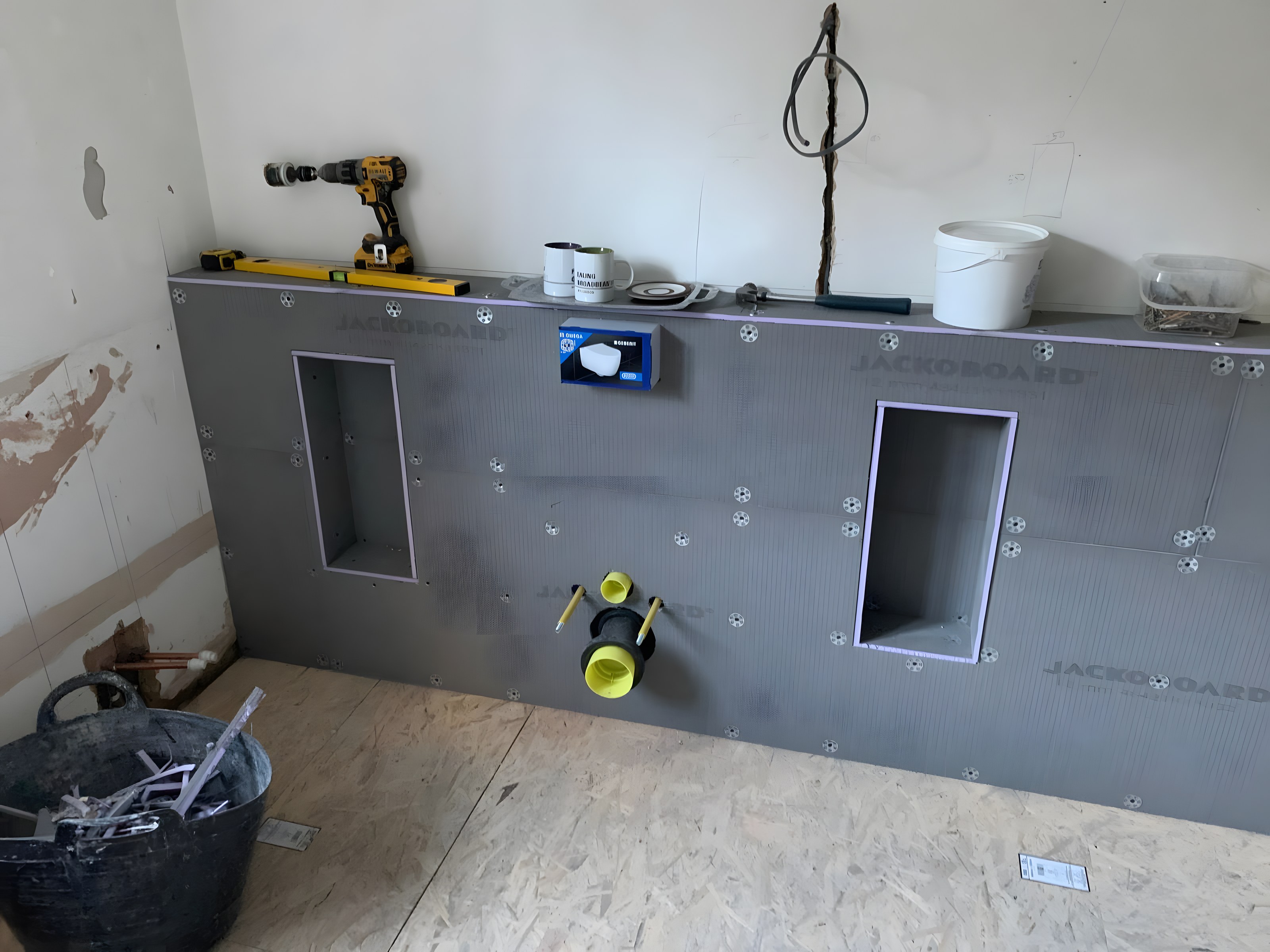 Wet room during installation with tile-backer boards and niches