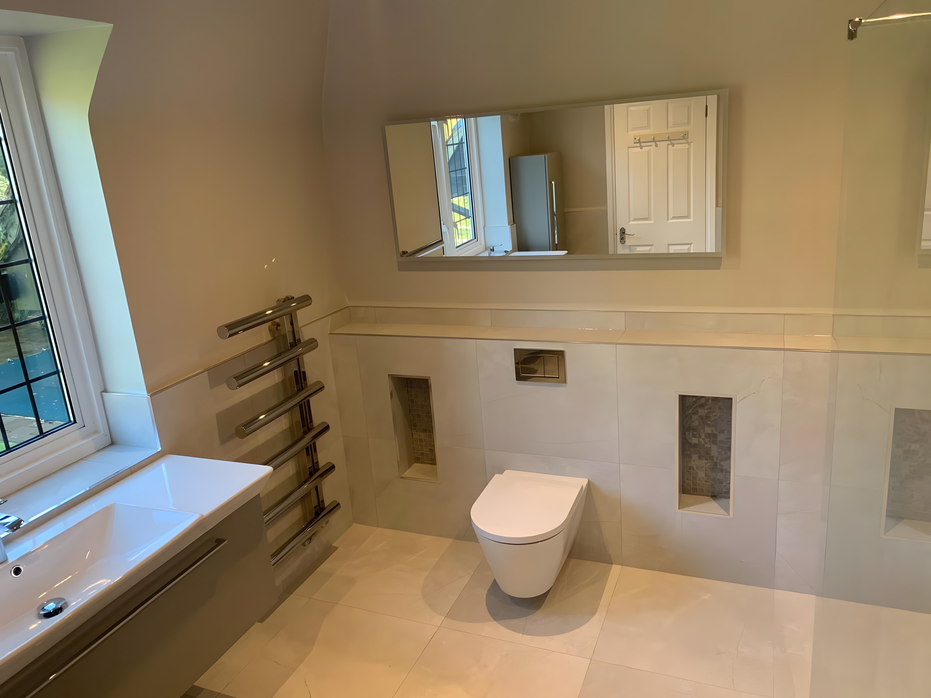Wet room with wall-hung WC and leaded windows